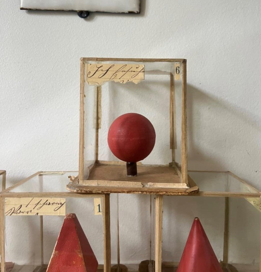 Set of Red Geometric Shapes in Individual Glass Cubes